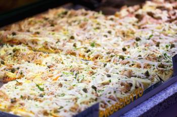 Focaccia bread topped with tuna salad and grated cheese