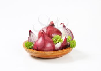 whole and quartered red onions