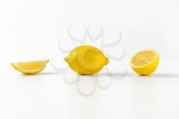 fresh juicy lemons - whole, half and wedge