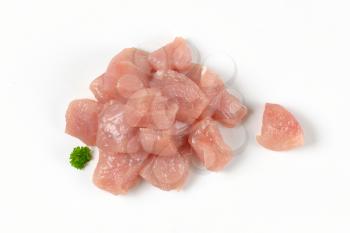 heap of diced turkey breast fillet on white background