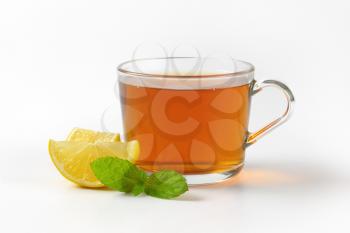 hot tea in glass cup and fresh lemon slices
