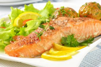 pan seared salmon fillet served with roasted potatoes and fresh vegetables