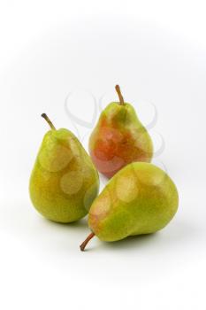 three ripe pears on white background