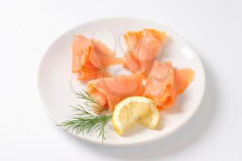 Thin smoked salmon slices on plate