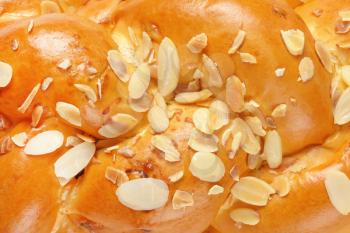detail of sweet braided bread topped with almonds