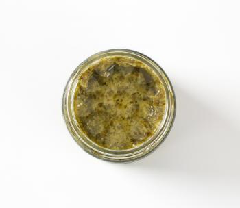 Jar of basil pesto with garlic, pine nuts and Parmesan cheese