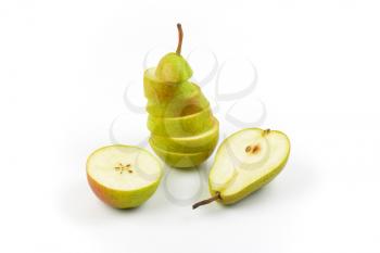 halved and sliced ripe pears on white background