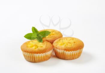 Custard filled lemon cupcakes on white background