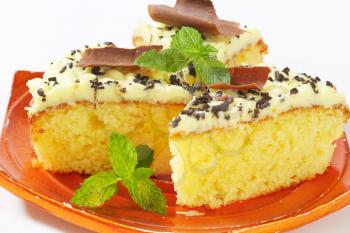 Sponge cake with lemon buttercream frosting on a plate