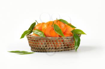 ripe tangerines in basket bowl