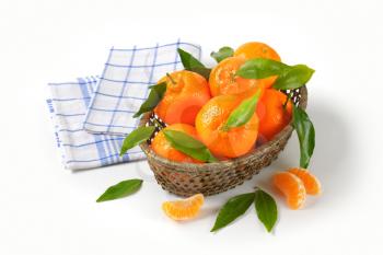 ripe tangerines in basket bowl