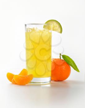 glass of mandarin juice with ice and ripe tangerine