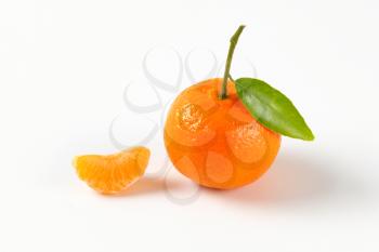 tangerine with separated segment on white background