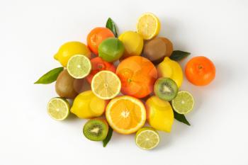 assortment of fresh citrus fruits and kiwi on white background