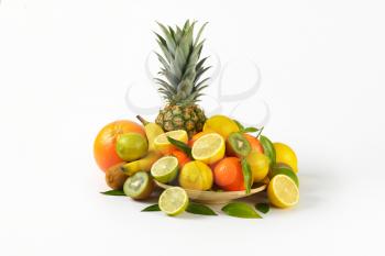 plate of fresh tropical fruit on white background