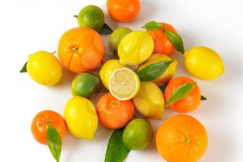 assortment of fresh citrus fruit on white background