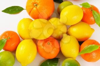 heap of fresh citrus fruit on white background