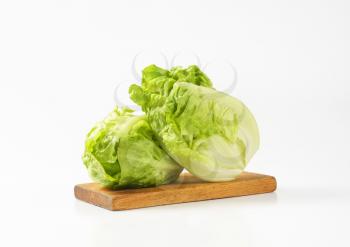 Fresh gem lettuce heads on cutting board