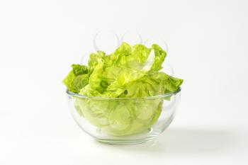Fresh little gem lettuce leaves in glass bowl