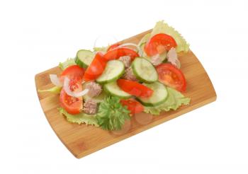 fresh vegetable salad with tuna on cutting board