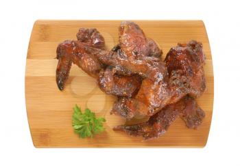 sweet and spicy BBQ chicken wings on cutting board