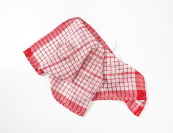 red and white crumpled dish towel on white background