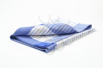 blue and white striped dish towel on white background