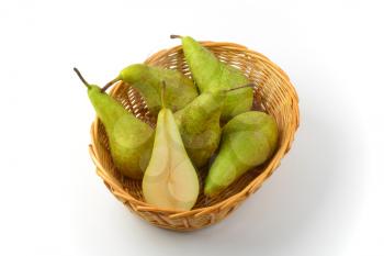 fresh green pears in wicker bowl