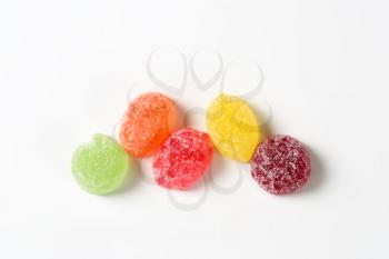 fruit jelly candies coated with sugar on white background