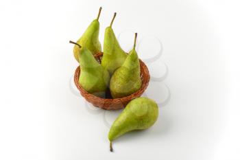 fresh green pears in wicker bowl