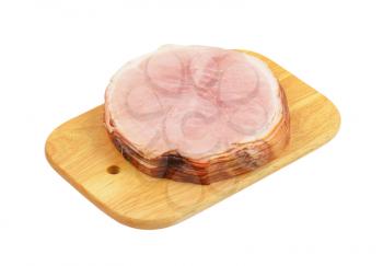 stack of ham slices on wooden cutting board