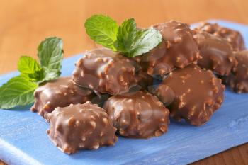 Marzipan squares dipped in chocolate and chopped nuts