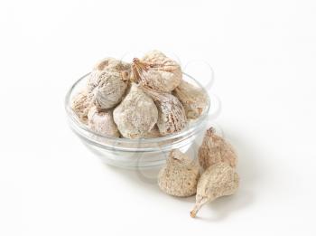 bowl of dried figs on white background