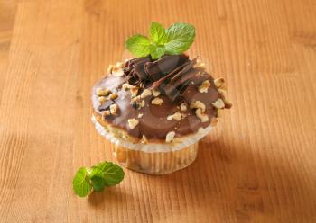Muffin topped with chocolate and nuts