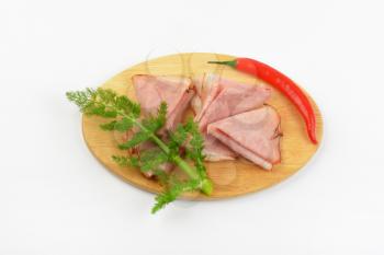 thin slices of ham and red chili pepper
