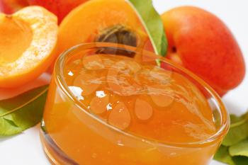 detail of fresh apricots and bowl of apricot jam