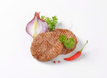 pan fried hamburger patties on white background