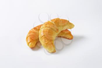 two jam filled croissants on white background