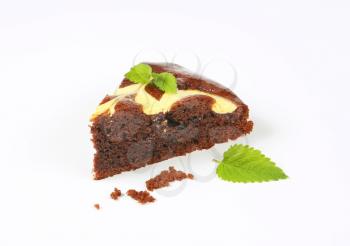 slice of chocolate cake with cream cheese on white background