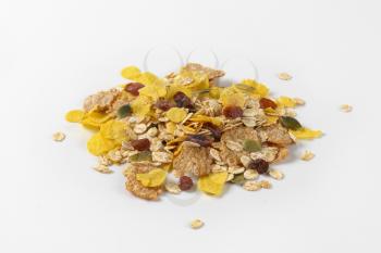 pile of mixed breakfast cereals with pieces of dried fruit