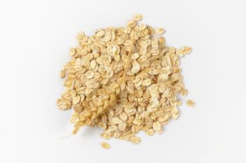 pile of oat flakes on white background