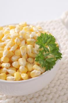 bowl of sweet corn kernels on white table mat