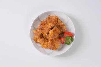 fried corn flake crusted chicken meat on white plate