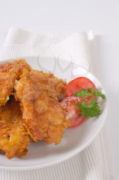 fried corn flake crusted chicken meat on white plate