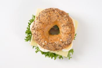 bagel sandwich with eggs and cheese on white background