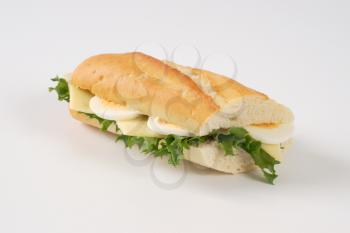 French bread sandwich with eggs and cheese on white background