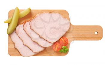 Thin slices of smoked pork roast on cutting board