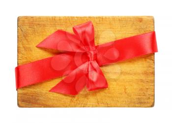 red ribbon bow tied over wooden cutting board