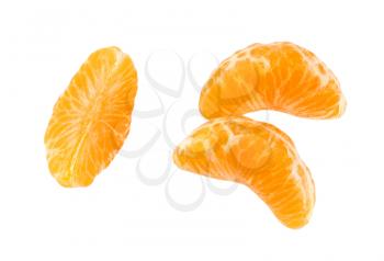 three separated segments of tangerine on white background