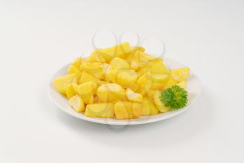 plate of pan fried potatoes on white background